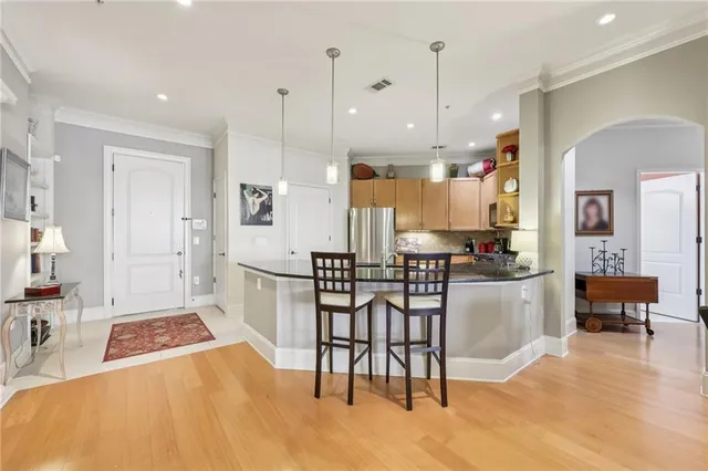 a kitchen with a refrigerator a oven and white cabinets