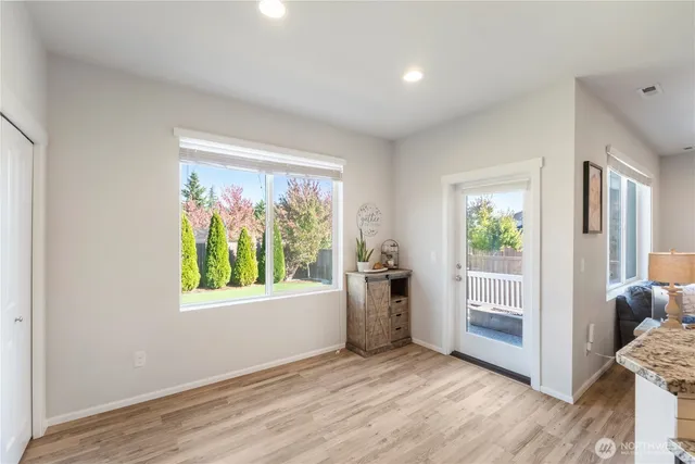 a living room with furniture fireplace and a window