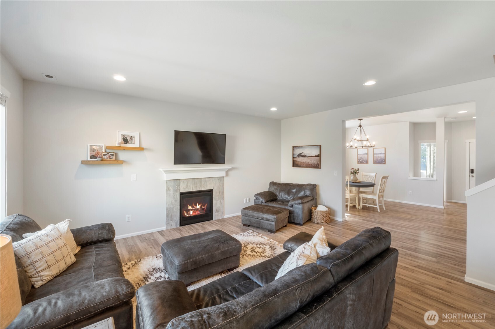 1002 O O'Farrell Lane Northwest Orting, WA 98360 - Photo 17 of 38 a living room with furniture a fireplace and a flat screen tv