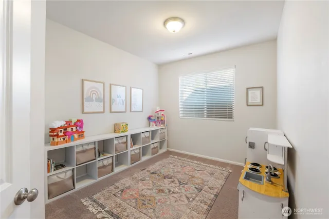 a large bedroom with a bed and window