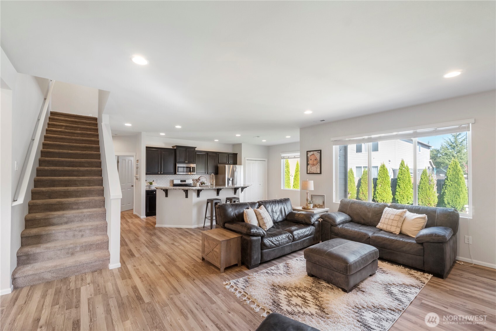 1002 O O'Farrell Lane Northwest Orting, WA 98360 - Photo 20 of 38 a living room with furniture and a wooden floor