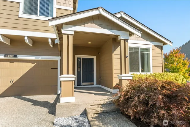 a view of a house with a yard and porch