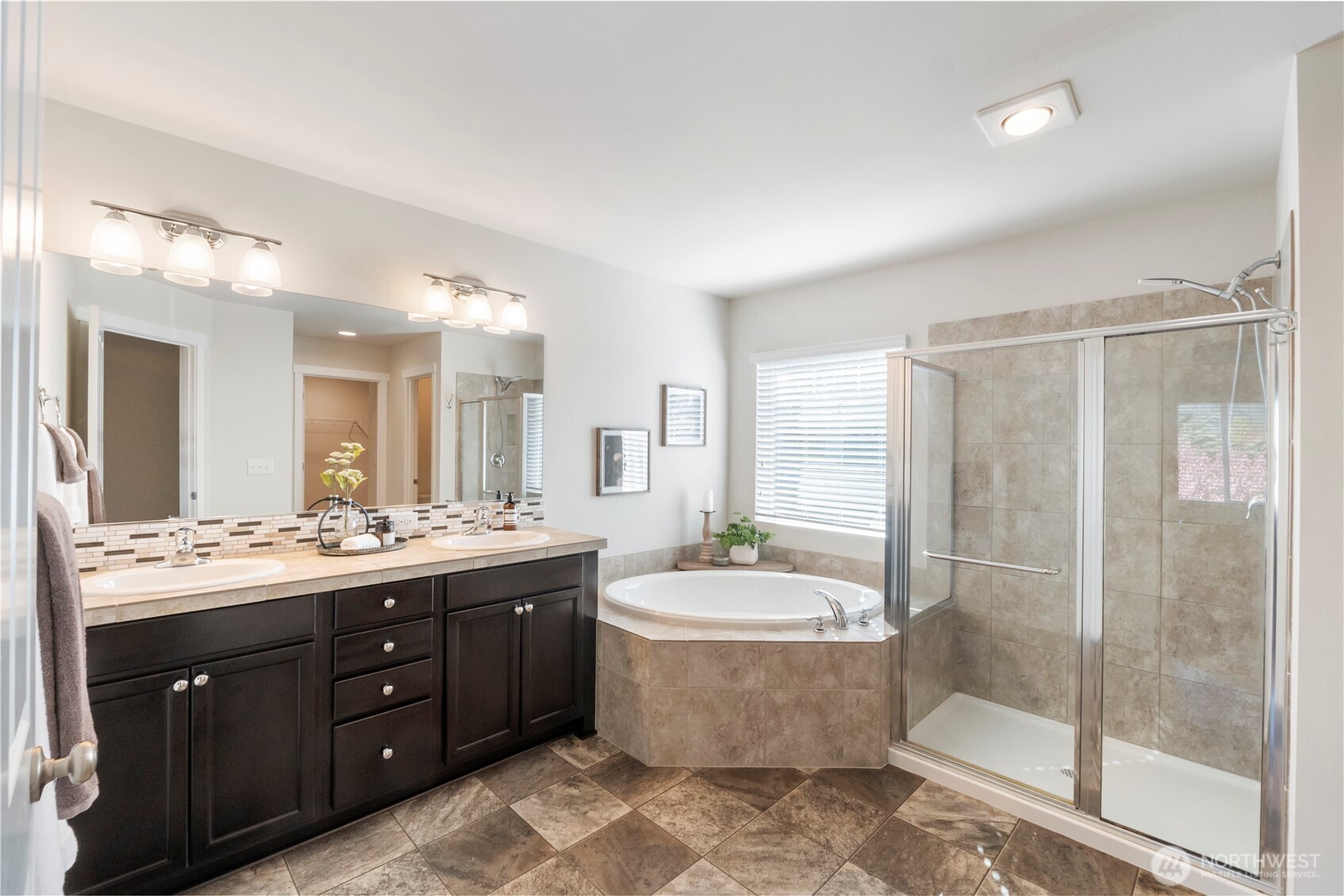 1002 O O'Farrell Lane Northwest Orting, WA 98360 - Photo 24 of 38 a bathroom with a double vanity sink mirror and bathtub