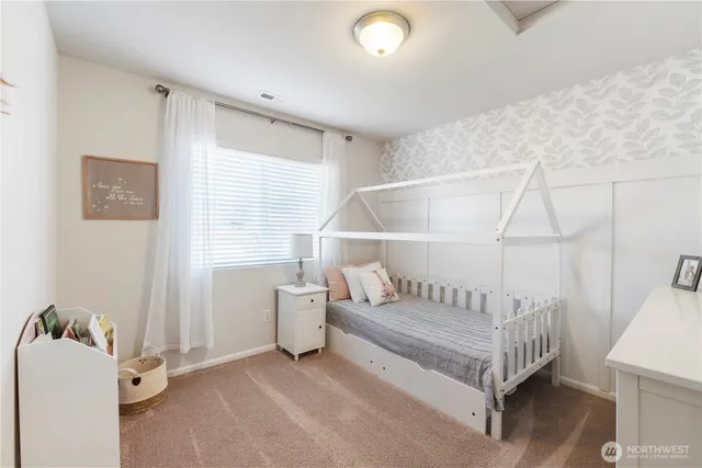 a spacious bedroom with a bed and a couch