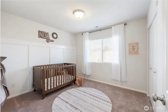 a spacious bedroom with a bed and a window