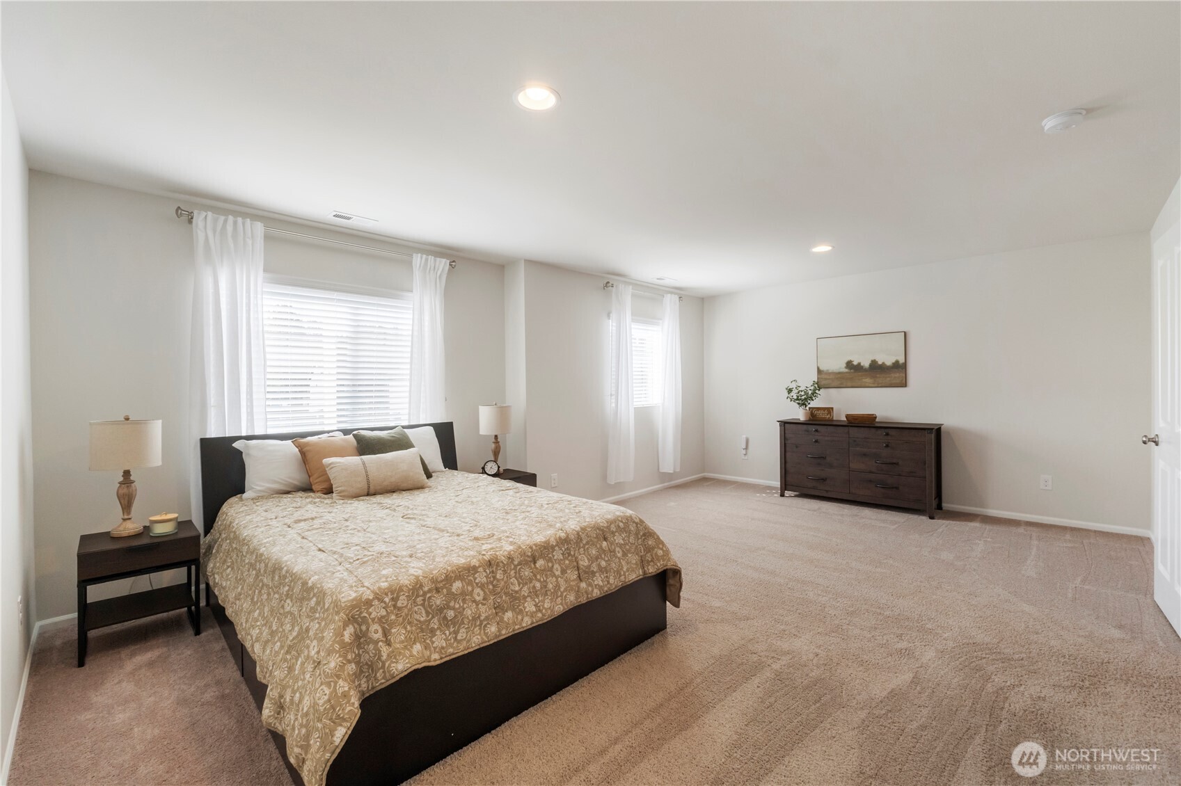 1002 O O'Farrell Lane Northwest Orting, WA 98360 - Photo 30 of 38 a spacious bedroom with a bed and a couch