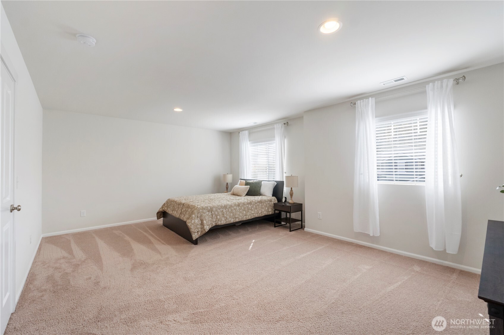 1002 O O'Farrell Lane Northwest Orting, WA 98360 - Photo 31 of 38 a spacious bedroom with a bed and a window