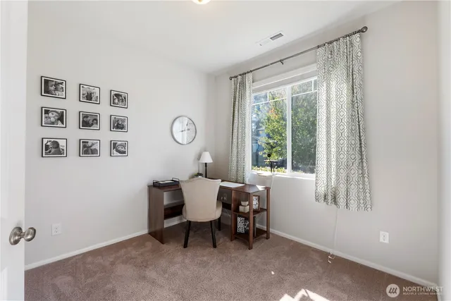 a kitchen with stainless steel appliances a table and chairs in it