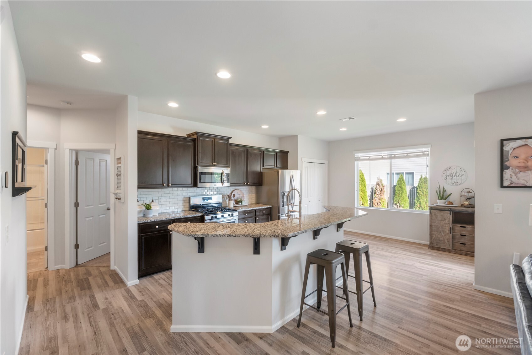 1002 O O'Farrell Lane Northwest Orting, WA 98360 - Photo 10 of 38 a kitchen with stainless steel appliances a table and chairs in it