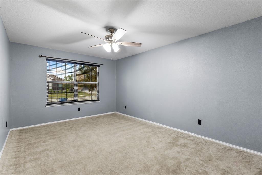 1014 Rio Frio Drive Forney, TX 75126 - Photo 7 of 19 Carpeted empty room featuring a ceiling fan and a textured ceiling