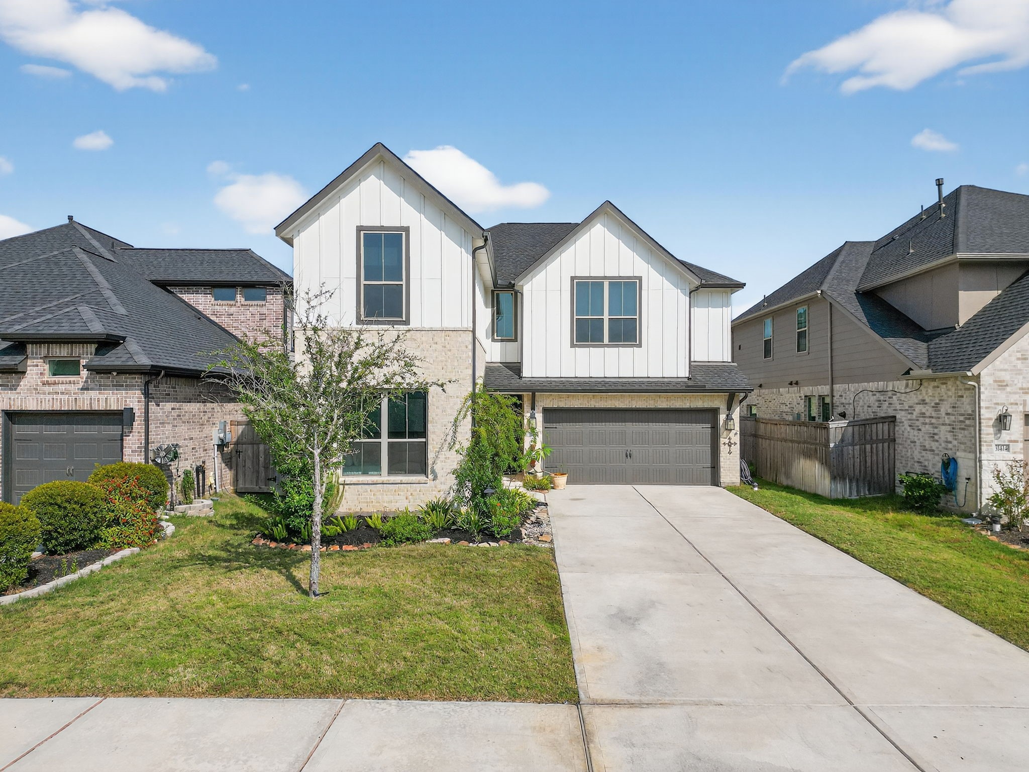 31418 Golden Cliffs Lane Fulshear, TX 77441 - Photo 2 of 48 a front view of a house with a yard and garage