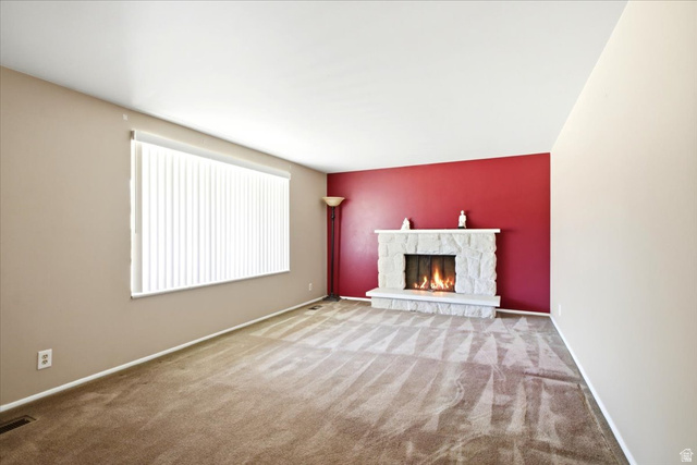 7050 South 260 East Midvale, UT 84047 - Photo 14 of 28 Living room featuring a stone-clad fireplace and hearth