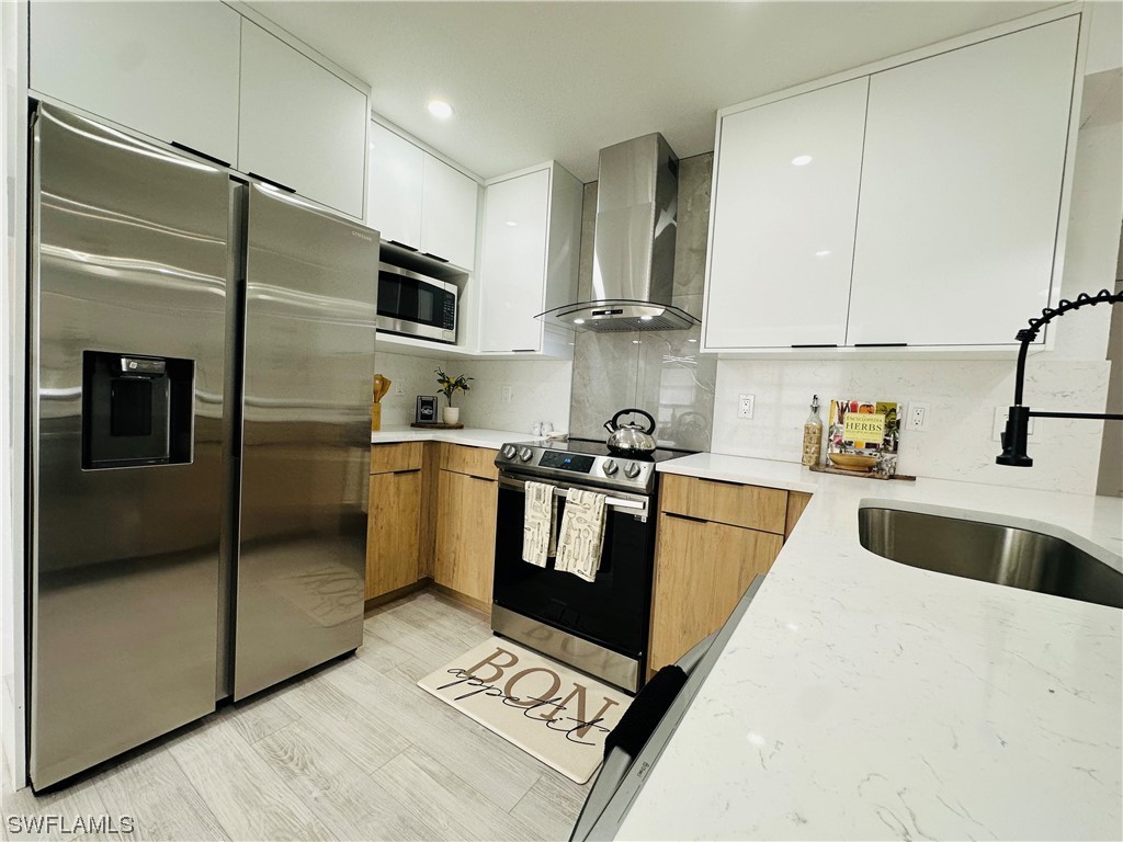 2926 Holly Road Fort Myers, FL 33901 - Photo 15 of 47 a kitchen with granite countertop a refrigerator and a sink