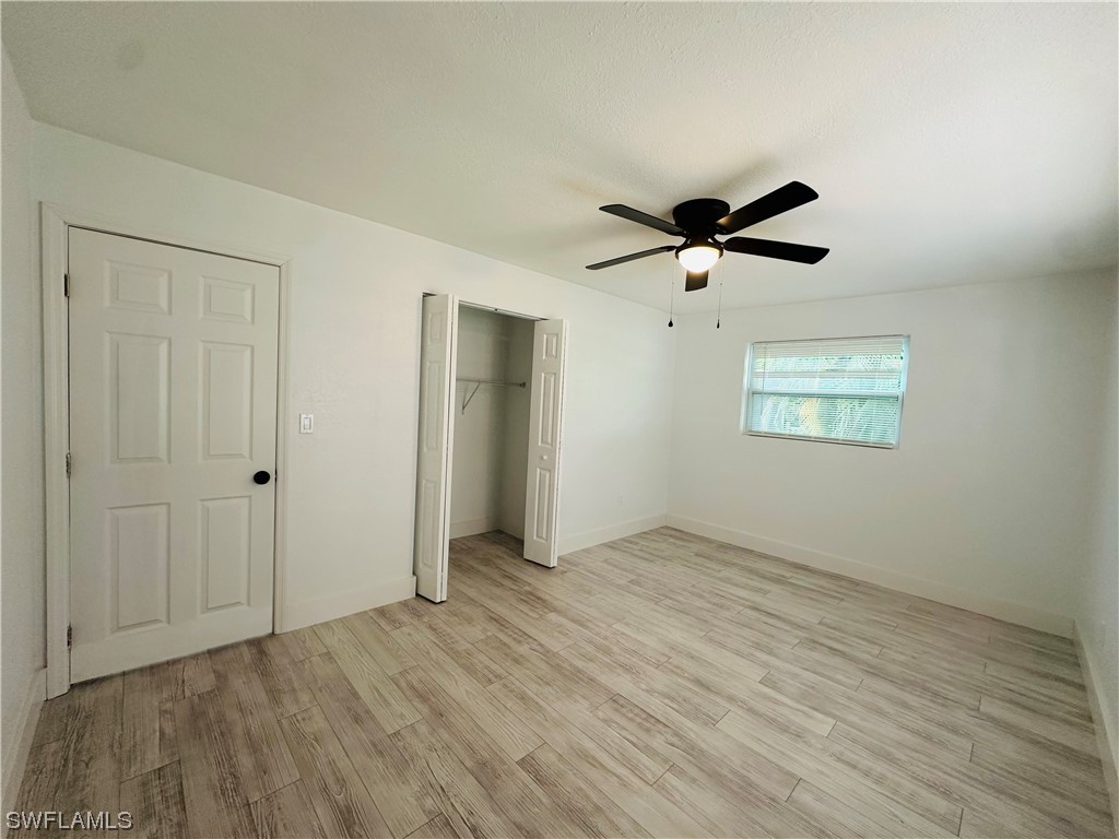 2926 Holly Road Fort Myers, FL 33901 - Photo 19 of 47 an empty room with fan and windows