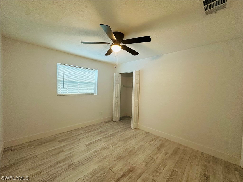 2926 Holly Road Fort Myers, FL 33901 - Photo 20 of 47 wooden floor in an empty room
