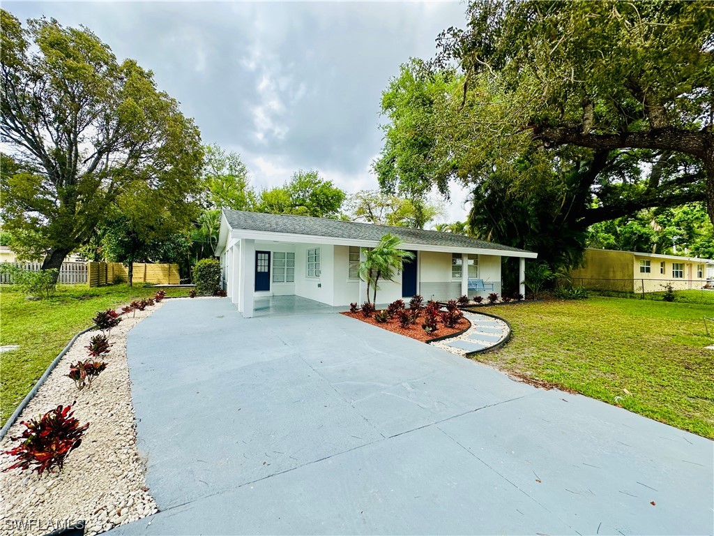 2926 Holly Road Fort Myers, FL 33901 - Photo 2 of 47 a view of a house with a yard and sitting area