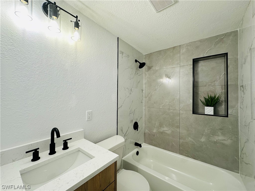 2926 Holly Road Fort Myers, FL 33901 - Photo 21 of 47 a bathroom with a sink a toilet and shower