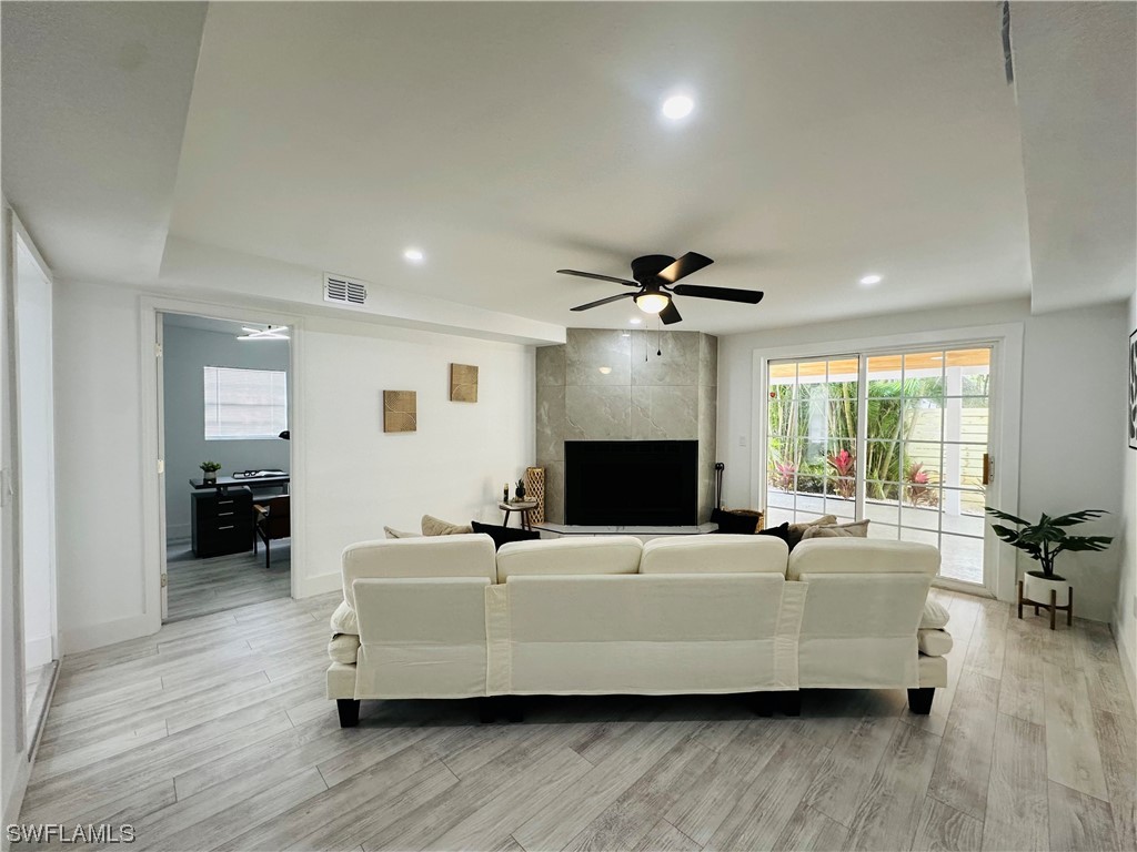 2926 Holly Road Fort Myers, FL 33901 - Photo 29 of 47 a living room with furniture and a fireplace