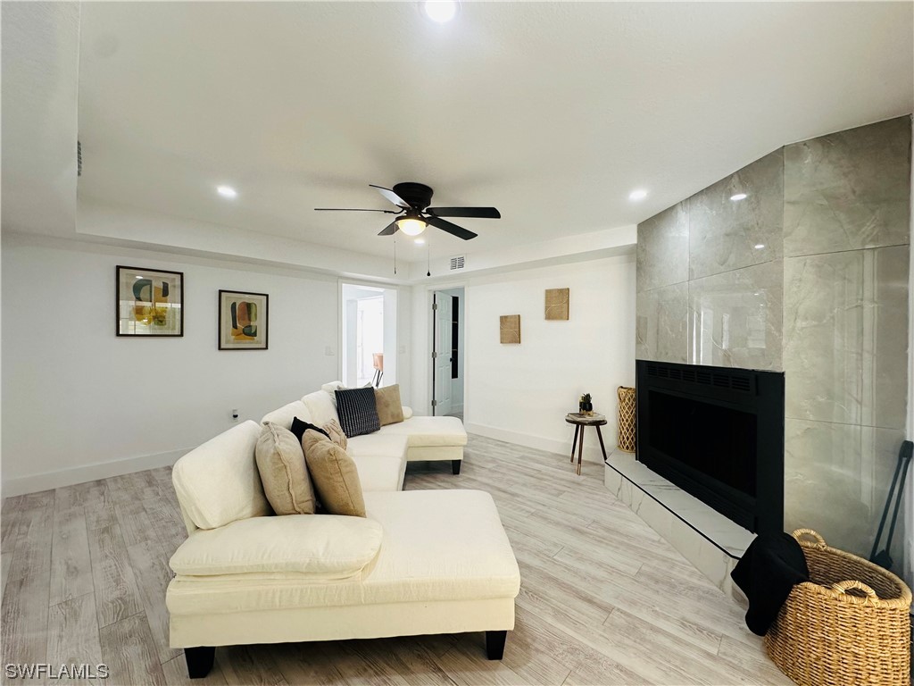 2926 Holly Road Fort Myers, FL 33901 - Photo 30 of 47 a living room with furniture and a flat screen tv