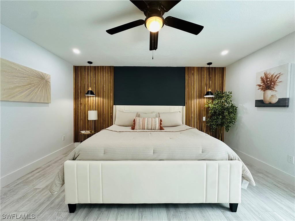 2926 Holly Road Fort Myers, FL 33901 - Photo 32 of 47 a bedroom with a bed and a painting on the wall