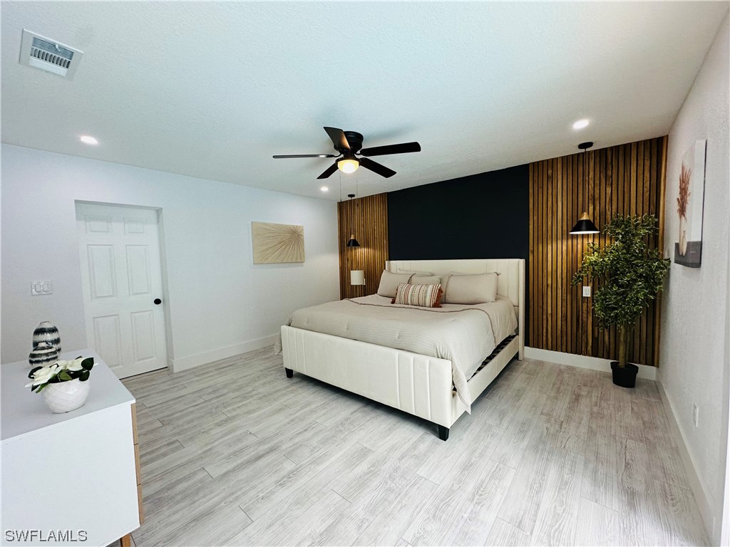 2926 Holly Road Fort Myers, FL 33901 - Photo 33 of 47 a bedroom with a bed and a ceiling fan