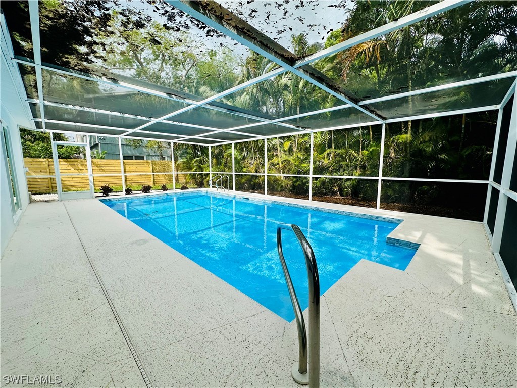 2926 Holly Road Fort Myers, FL 33901 - Photo 37 of 47 a view of a swimming pool with a yard and sitting area