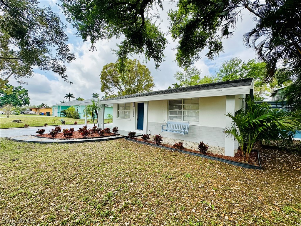 2926 Holly Road Fort Myers, FL 33901 - Photo 4 of 47 a view of a house with swimming pool and sitting area