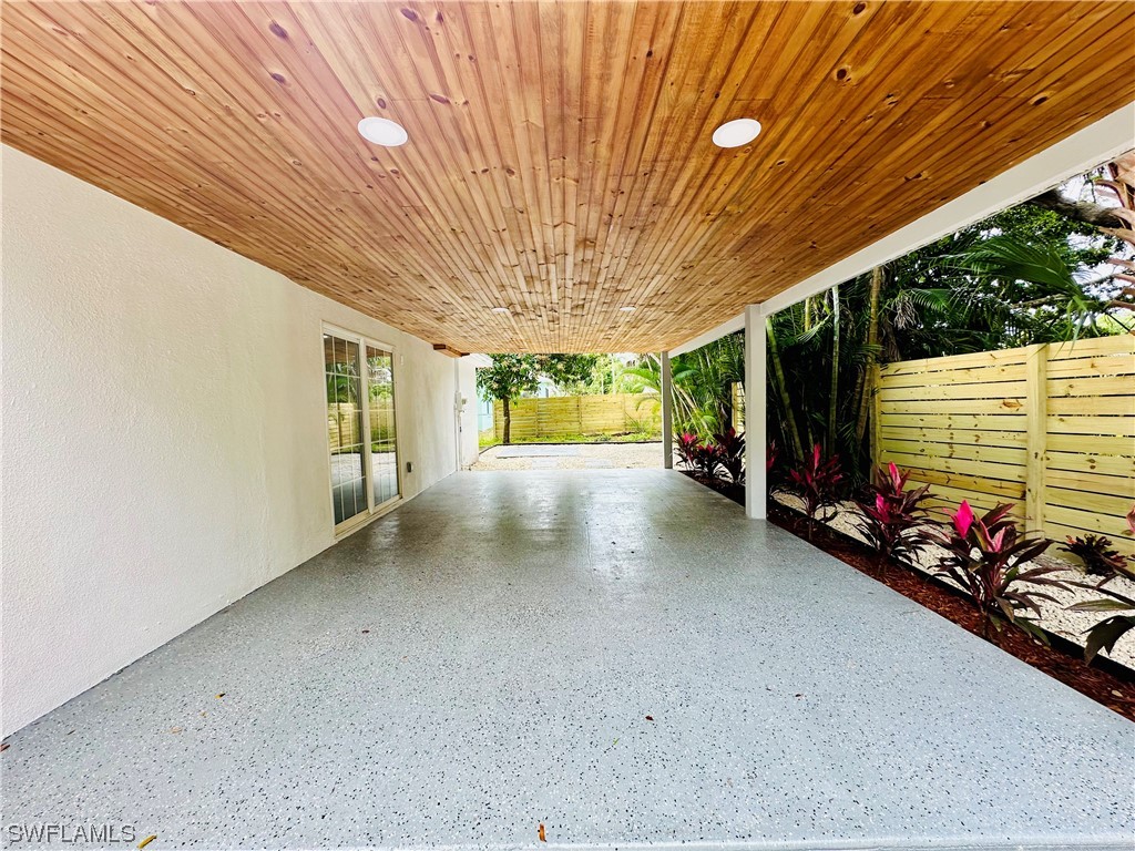 2926 Holly Road Fort Myers, FL 33901 - Photo 41 of 47 a view of a patio with table and chairs and potted plants