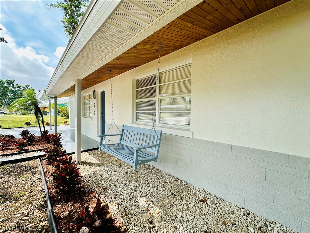 2926 Holly Road Fort Myers, FL 33901 - Photo 5 of 47 a front view of a house with garden