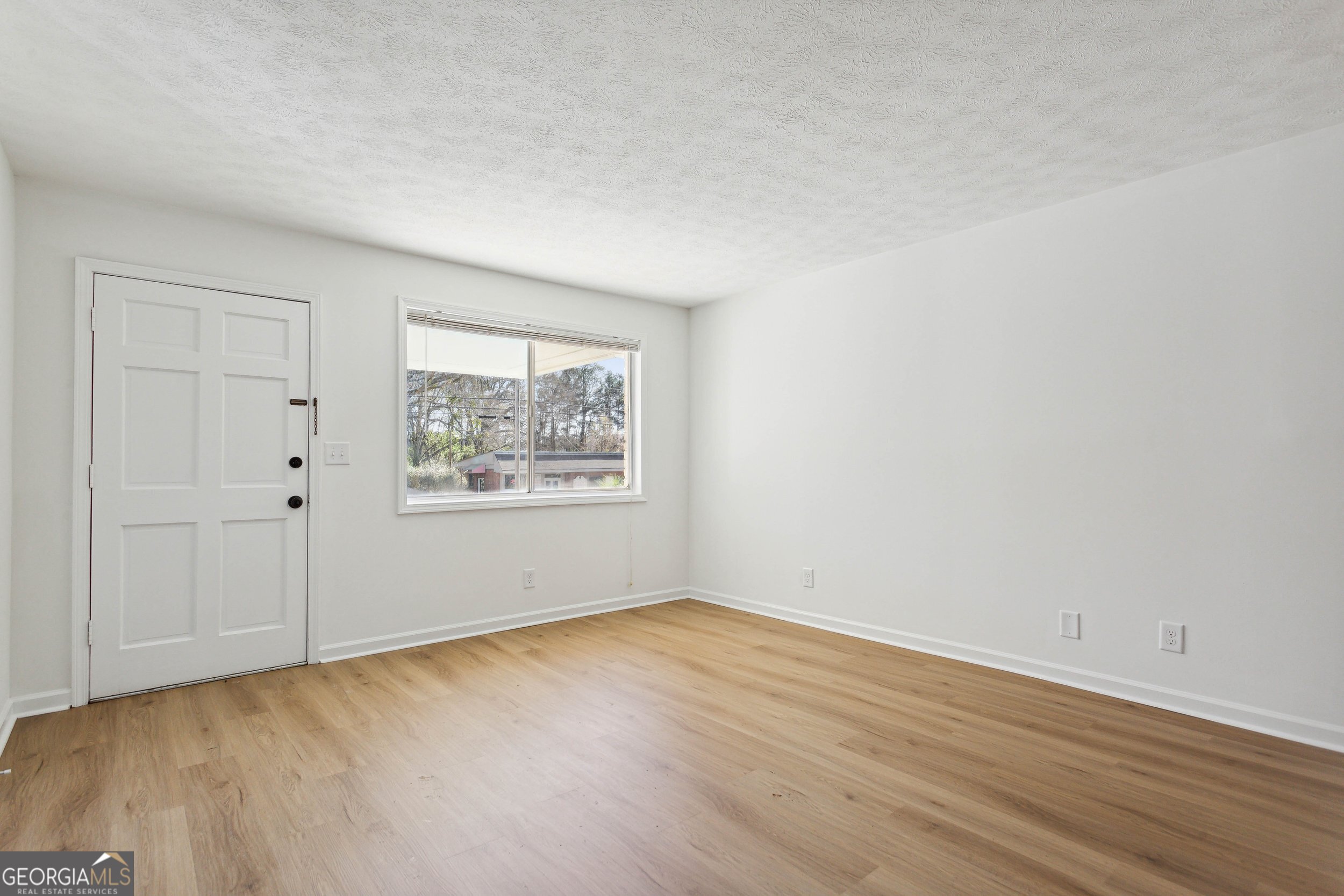 144 Jackson Street Newnan, GA 30263 - Photo 14 of 19 a view of an empty room with wooden floor and a window