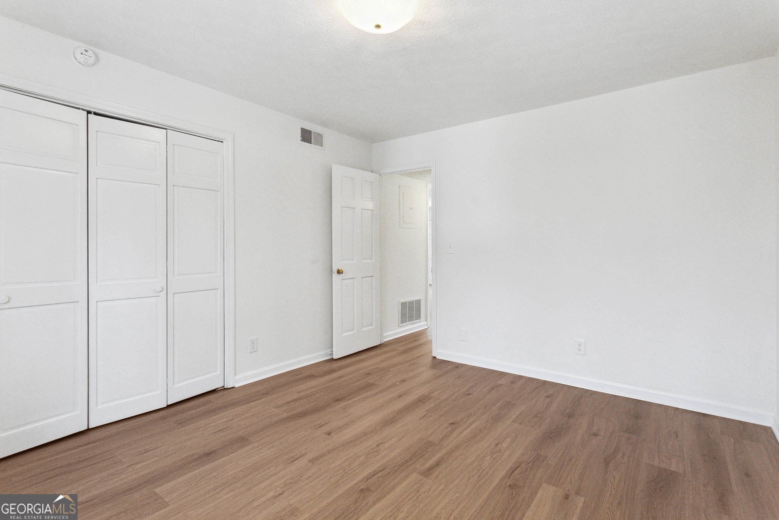 144 Jackson Street Newnan, GA 30263 - Photo 15 of 19 a view of an empty room with wooden floor