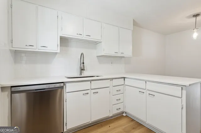 a kitchen with cabinets stainless steel appliances and a sink