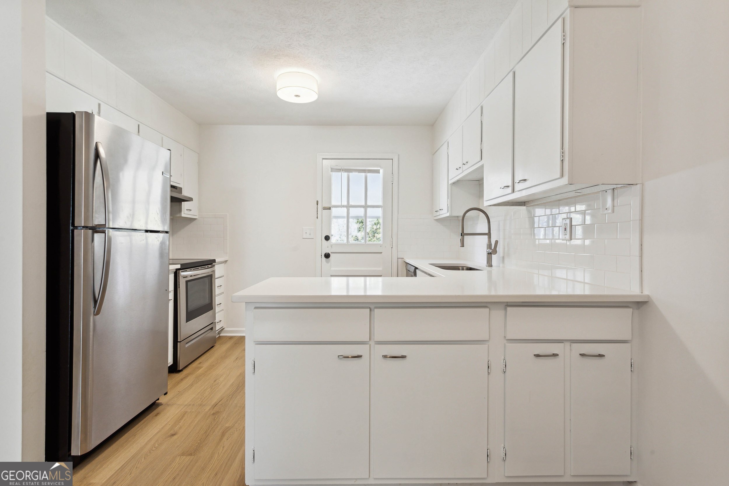 144 Jackson Street Newnan, GA 30263 - Photo 17 of 19 a kitchen with cabinets stainless steel appliances and a sink