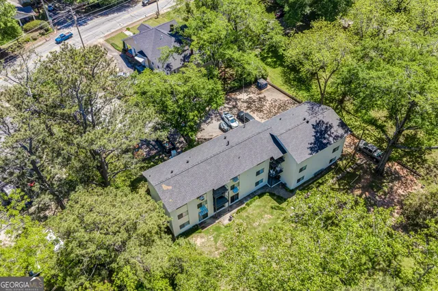an aerial view of a house with a yard