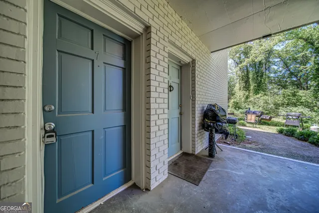 a view of a porch with furniture and a yard