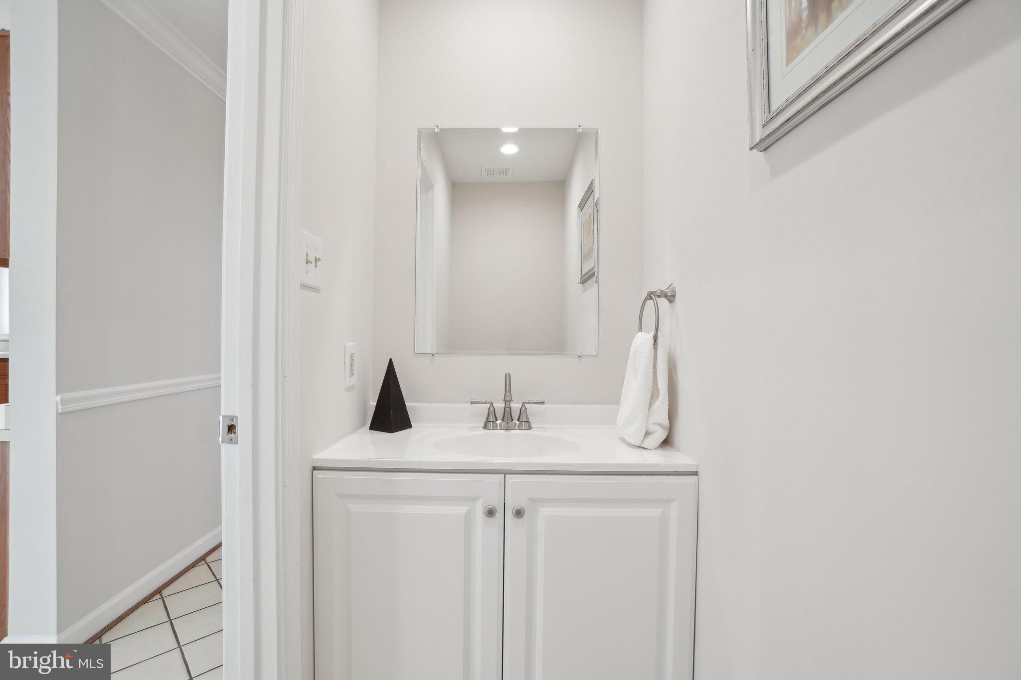 15301 Watergate Road Silver Spring, MD 20905 - Photo 12 of 51 a bathroom with a granite countertop sink and a mirror