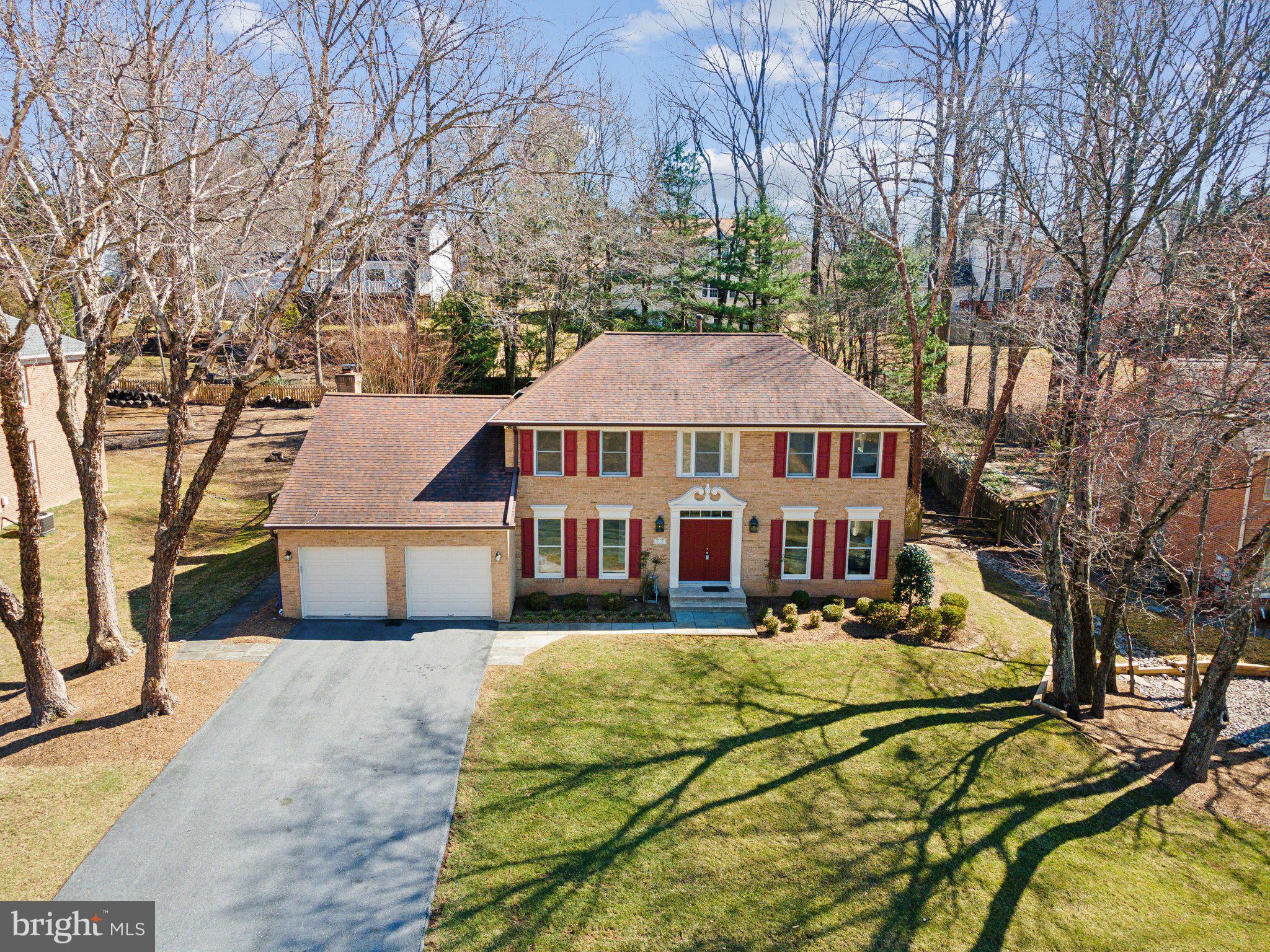 15301 Watergate Road Silver Spring, MD 20905 - Photo 36 of 51 a view of a white house with a yard patio and fire pit
