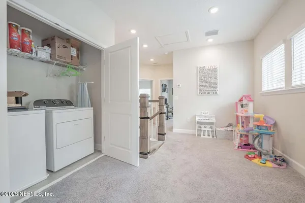a living room with furniture a air conditioner vent and a window