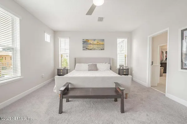 a bedroom with a bed and ceiling fan