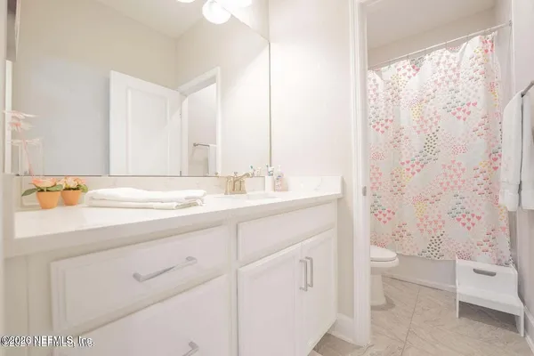 a view of a bedroom with wooden floor
