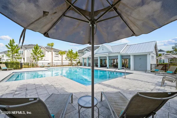 a view of a house with swimming pool and sitting area