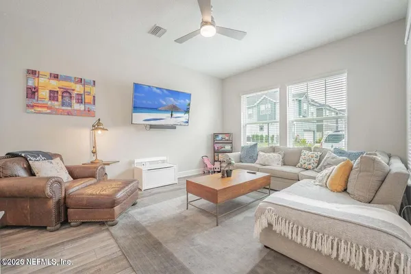 a living room with furniture and a large window