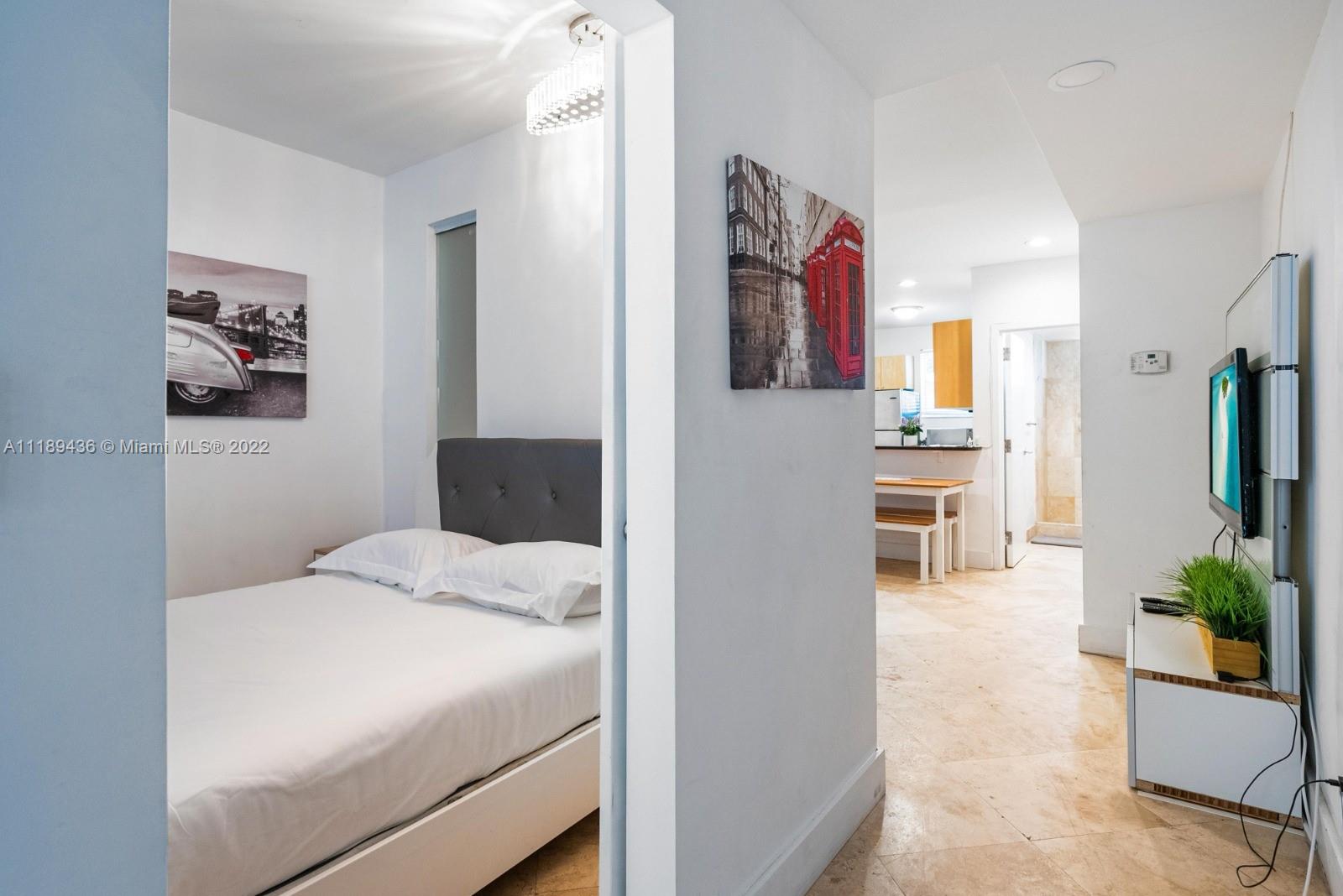 751 Collins Avenue, Unit 6 Miami Beach, FL 33139 - Photo 11 of 15 a bedroom with a bed and a view of bathroom