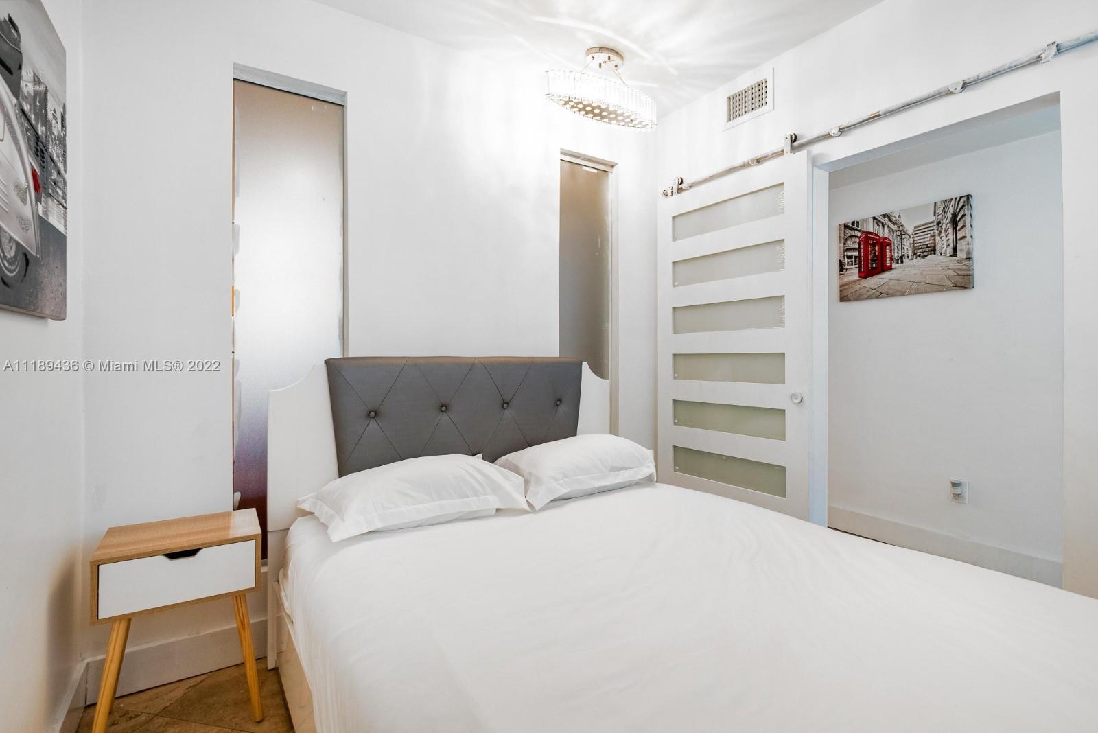 751 Collins Avenue, Unit 6 Miami Beach, FL 33139 - Photo 13 of 15 a bedroom with a bed and a window