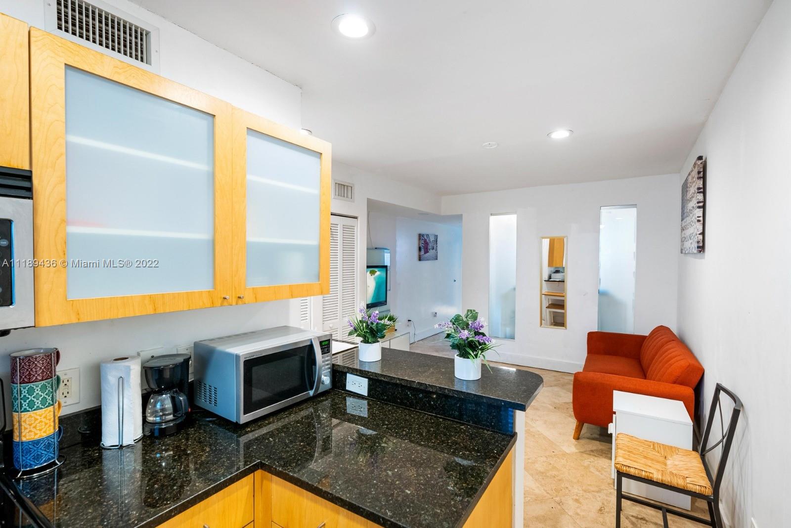 751 Collins Avenue, Unit 6 Miami Beach, FL 33139 - Photo 3 of 15 a living room with furniture fireplace and a window