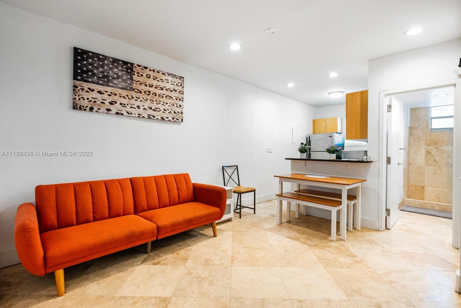 751 Collins Avenue, Unit 6 Miami Beach, FL 33139 - Photo 8 of 15 a living room with furniture a couch and a potted plant