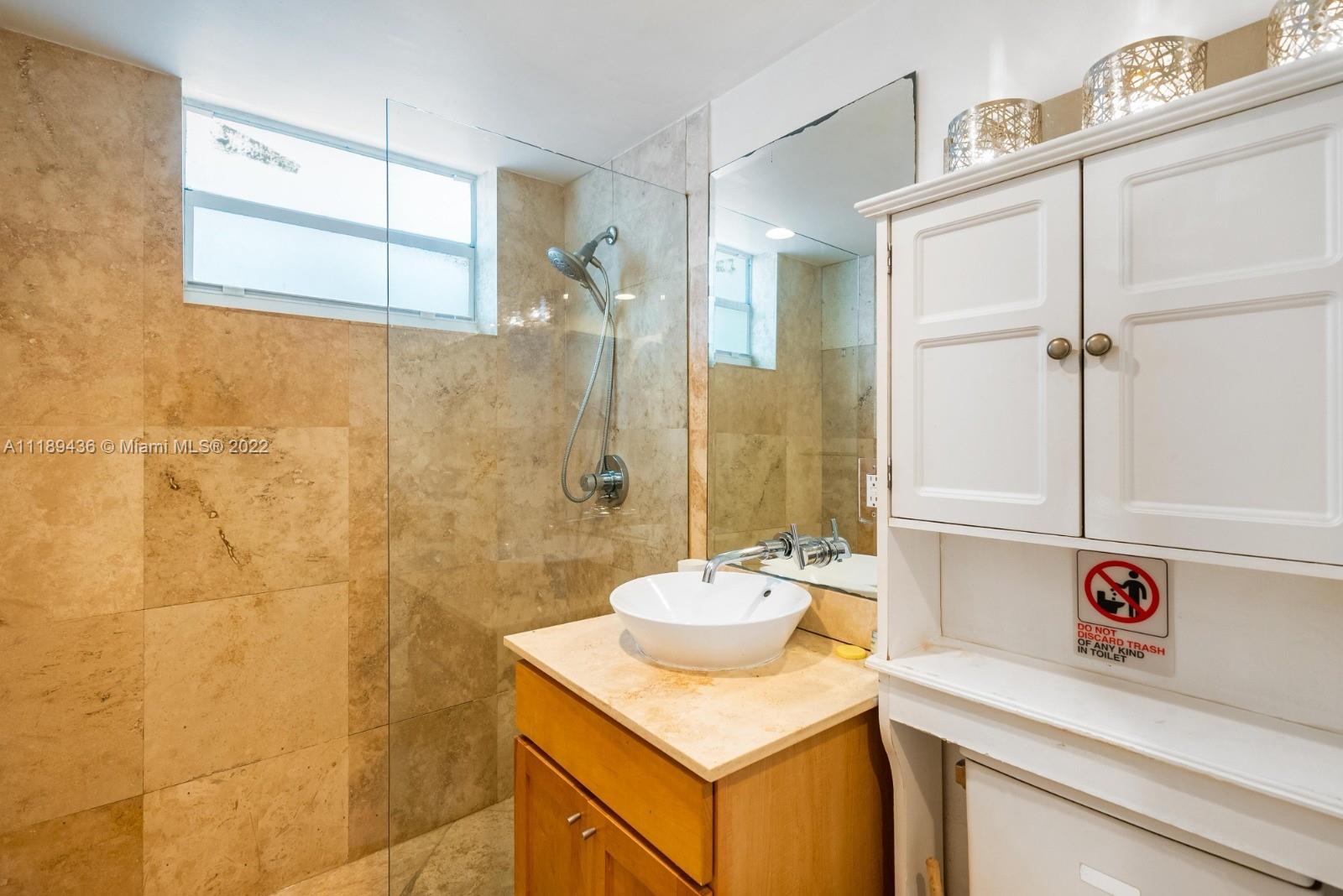 751 Collins Avenue, Unit 6 Miami Beach, FL 33139 - Photo 10 of 15 a bathroom with a sink and a mirror