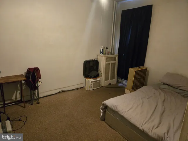 a bedroom with a bed dresser and a mirror