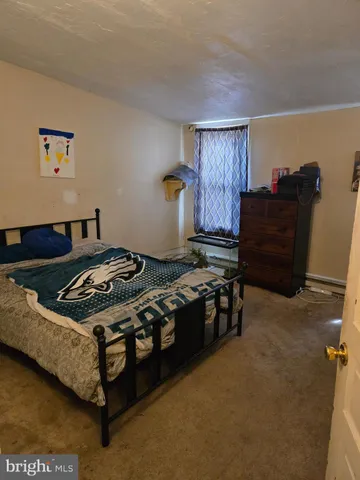 a view of a patio with table and chairs potted plants and a large tree