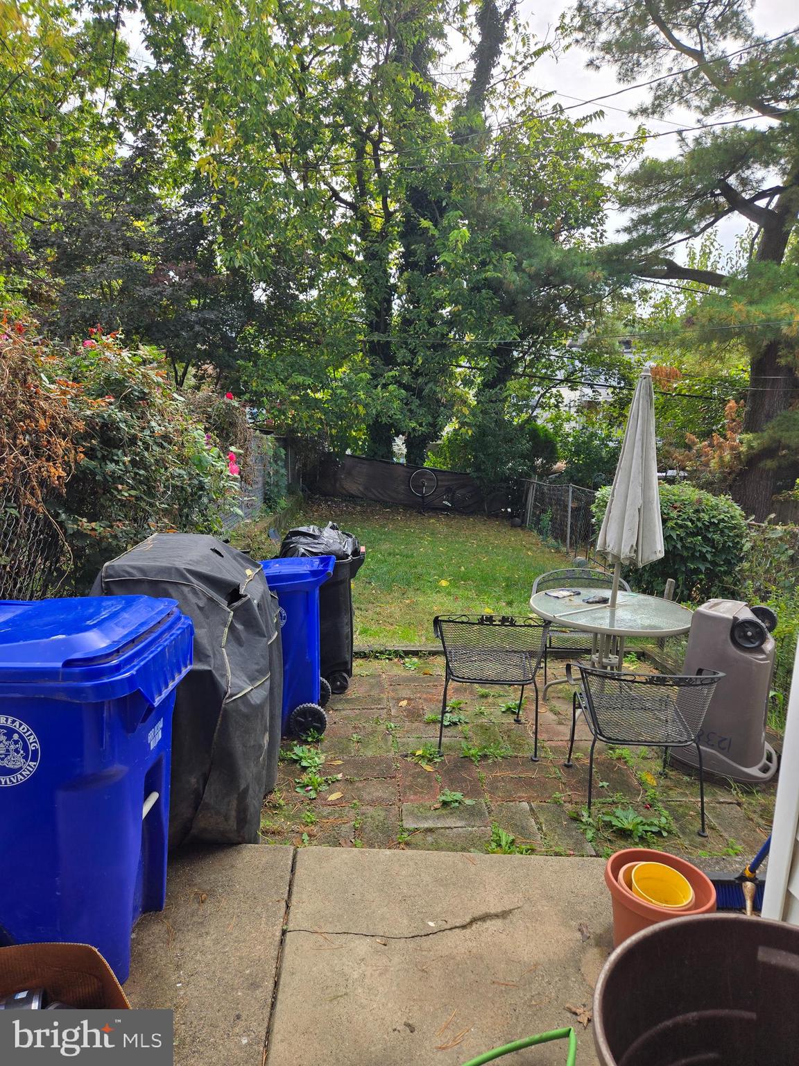 1238 Eckert Avenue Reading, PA 19602 - Photo 15 of 15 a view of a patio with table and chairs potted plants and a large tree